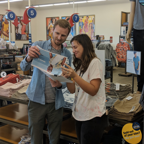 Garrett Ledbetter, General Manager at Old Navy reading something with a colleague